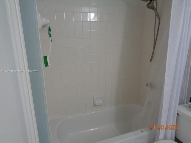 bathroom with toilet and shower / bath combo with shower curtain