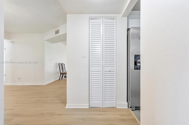 4050 NW 42nd Ave Unit 318, Fort Lauderdale, FL 33319 - hallway with light hardwood / wood-style floors and a textured ceiling
