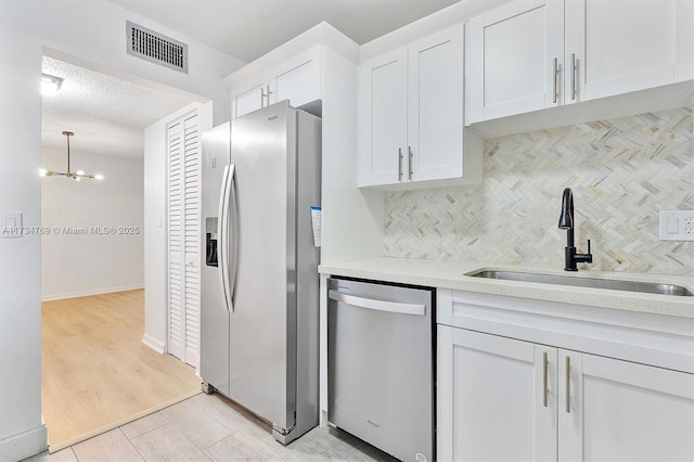 4050 NW 42nd Ave Unit 318, Fort Lauderdale, FL 33319 - kitchen with tasteful backsplash, stainless steel appliances, sink, and white cabinets