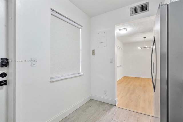4050 NW 42nd Ave Unit 318, Fort Lauderdale, FL 33319 - corridor with light hardwood / wood-style flooring and a textured ceiling