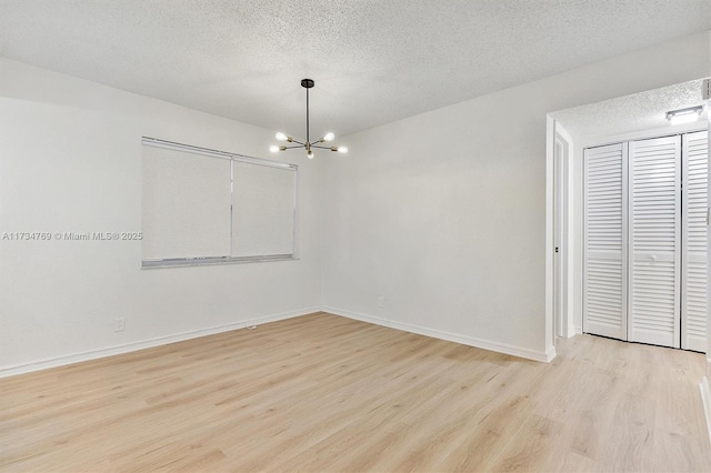 4050 NW 42nd Ave Unit 318, Fort Lauderdale, FL 33319 - spare room with a chandelier, a textured ceiling, and light wood-type flooring