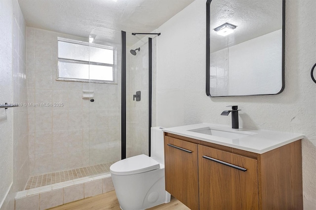 4050 NW 42nd Ave Unit 318, Fort Lauderdale, FL 33319 - bathroom featuring vanity, a textured ceiling, toilet, and a tile shower