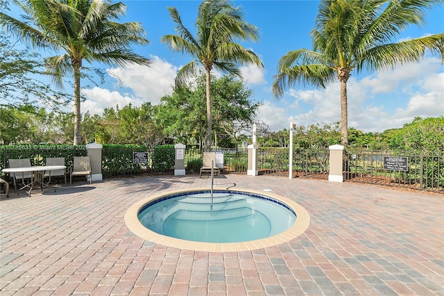 view of pool with a patio and a community hot tub