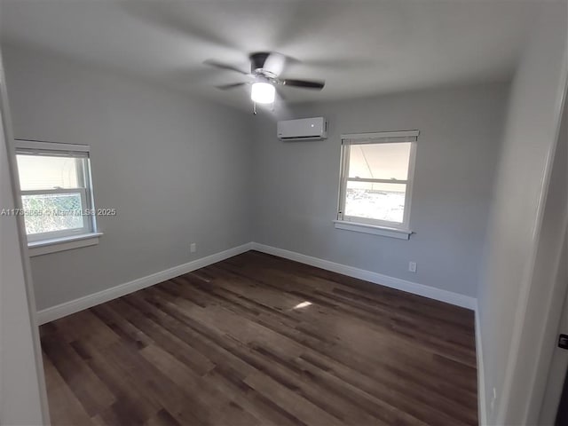 empty room featuring ceiling fan, dark hardwood / wood-style flooring, and a wall unit AC