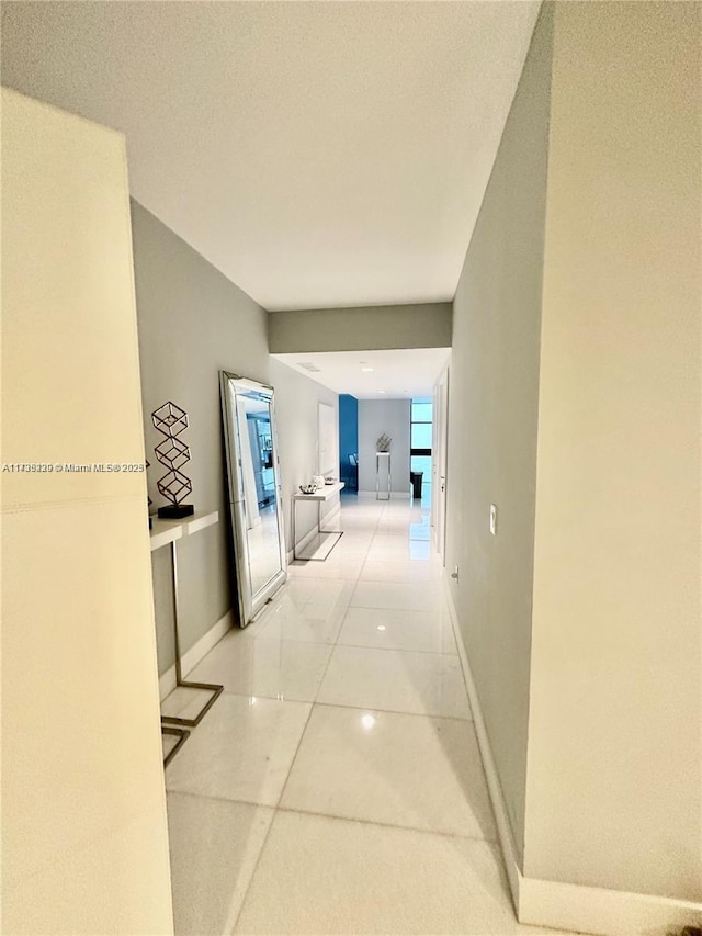 corridor featuring light tile patterned flooring