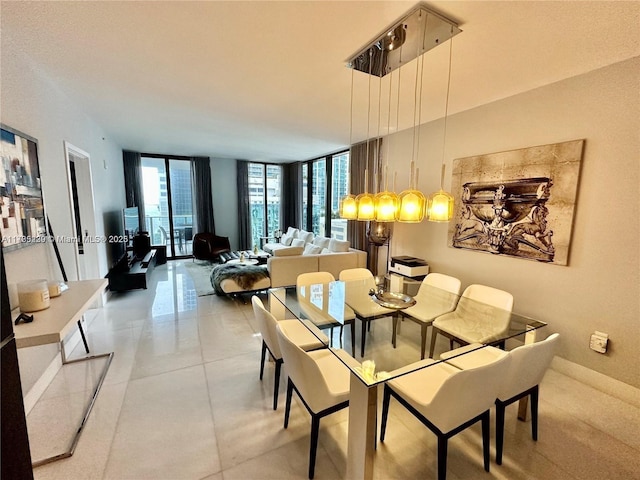 dining room featuring light tile patterned flooring, plenty of natural light, and a wall of windows