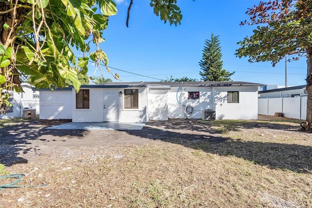 back of house with central AC unit and a patio