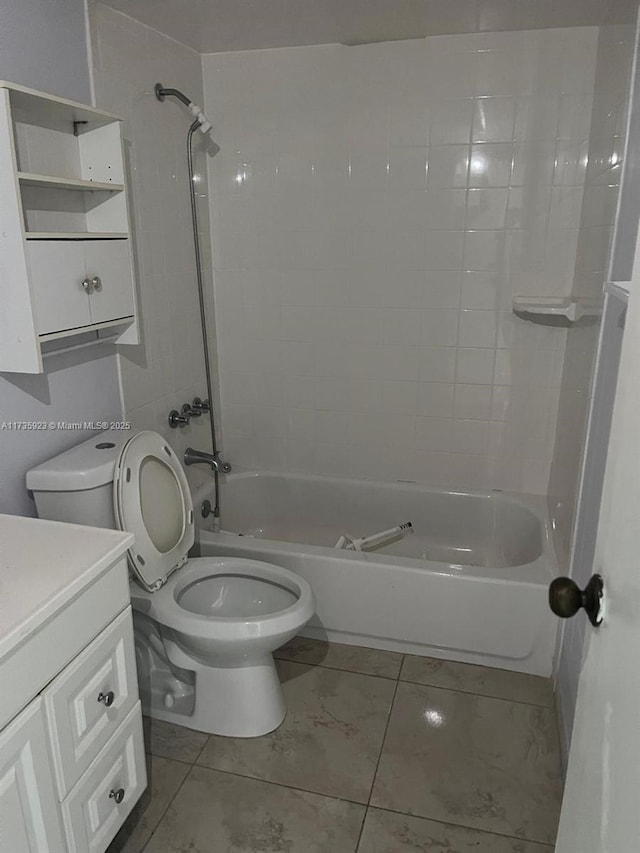 full bathroom featuring tiled shower / bath, vanity, and toilet