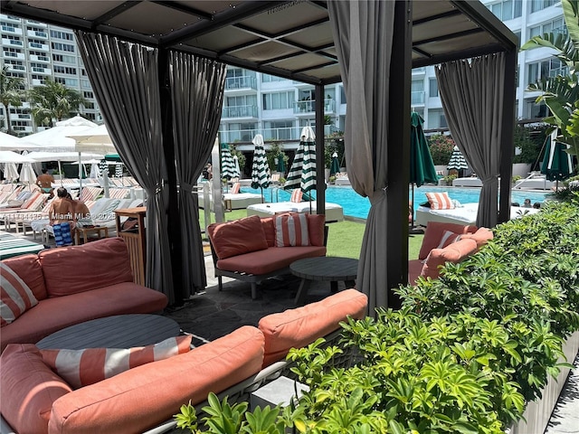 view of patio featuring a community pool and outdoor lounge area