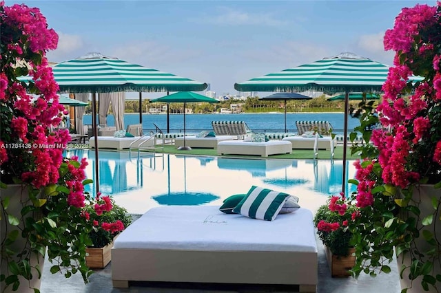 view of swimming pool featuring a water view