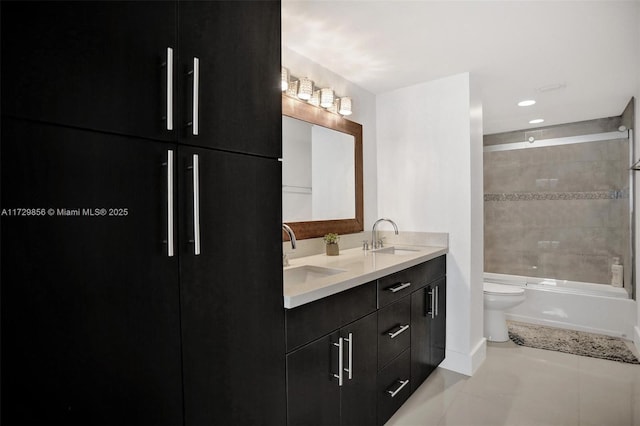 full bathroom featuring vanity, tiled shower / bath, tile patterned floors, and toilet