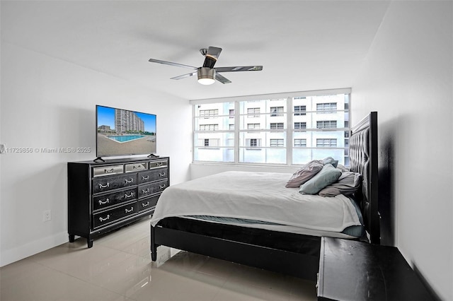 tiled bedroom with ceiling fan