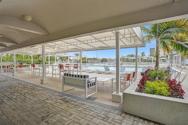 view of patio / terrace with a community pool and ceiling fan