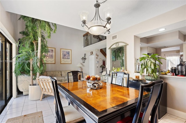 dining area with an inviting chandelier and light tile patterned flooring