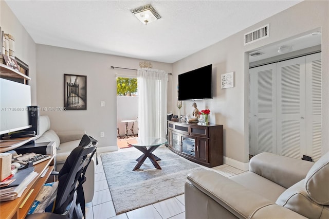 office space with light tile patterned flooring and a fireplace