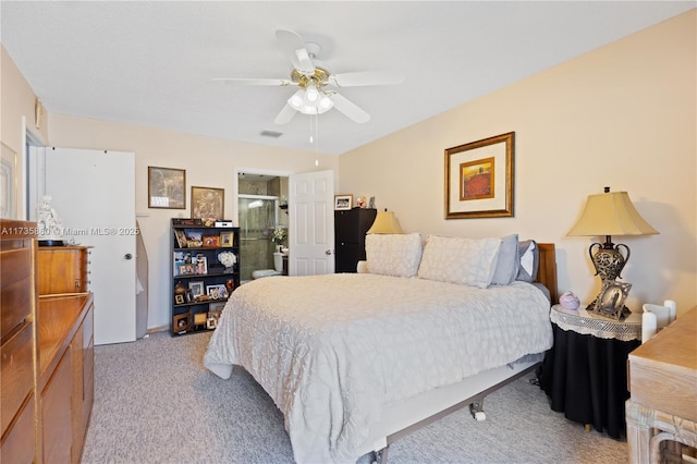 carpeted bedroom featuring ceiling fan and ensuite bathroom