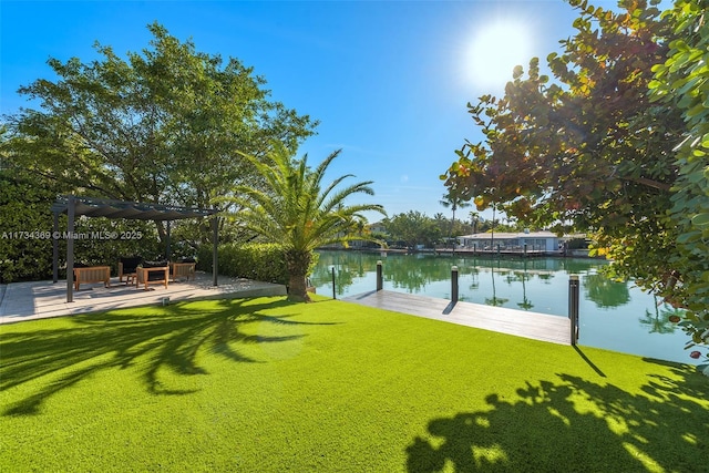 view of yard featuring a pergola, a boat dock, and a water view