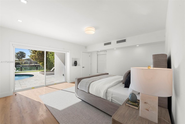 bedroom featuring hardwood / wood-style floors and access to outside