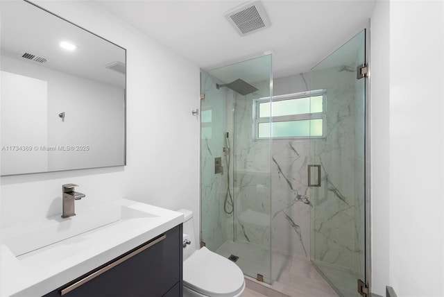 bathroom featuring vanity, toilet, and an enclosed shower