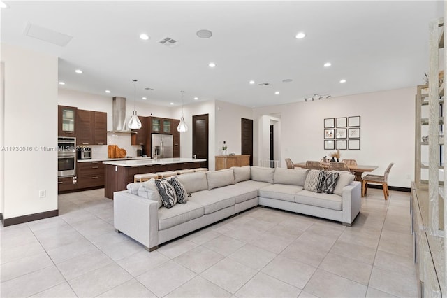 living room featuring light tile patterned floors, baseboards, visible vents, and recessed lighting