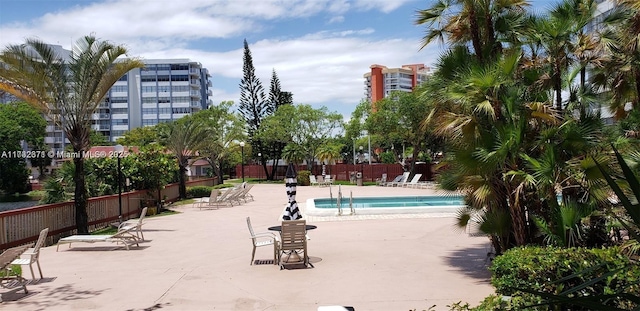 pool with a patio and fence