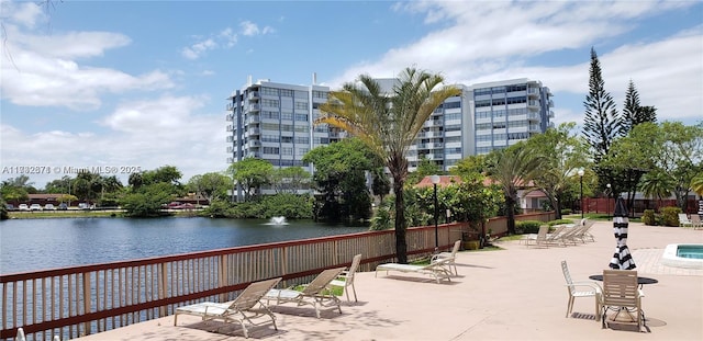 view of home's community featuring fence and a water view