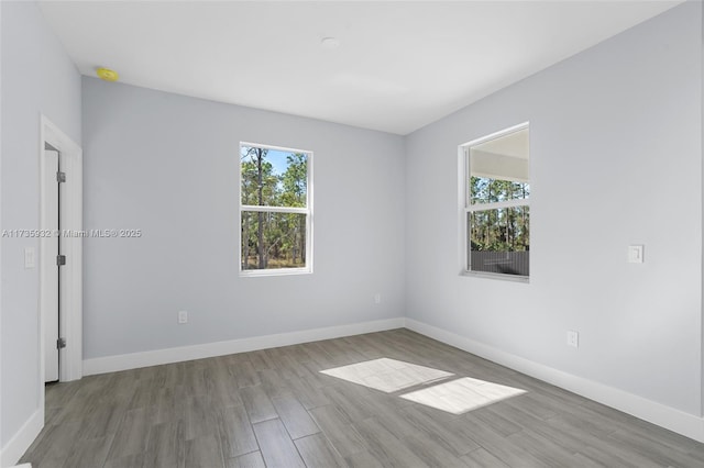 unfurnished room featuring light hardwood / wood-style flooring and a wealth of natural light