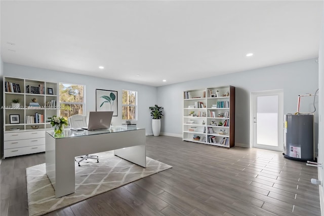 unfurnished office featuring gas water heater and wood-type flooring