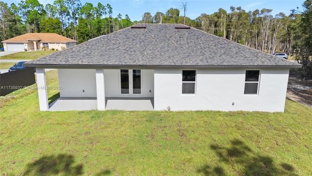 back of house featuring a yard and a patio