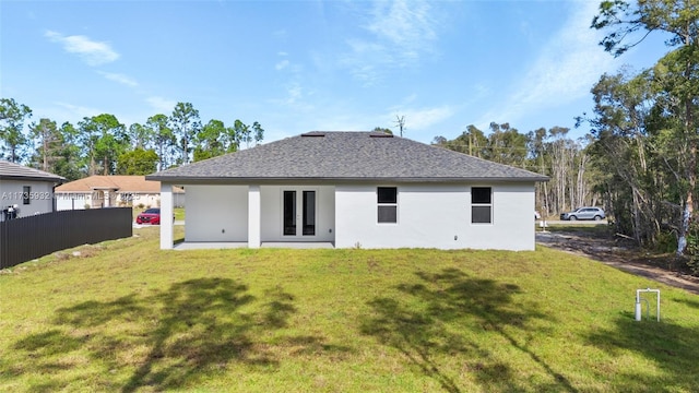 back of property featuring a yard and a patio area