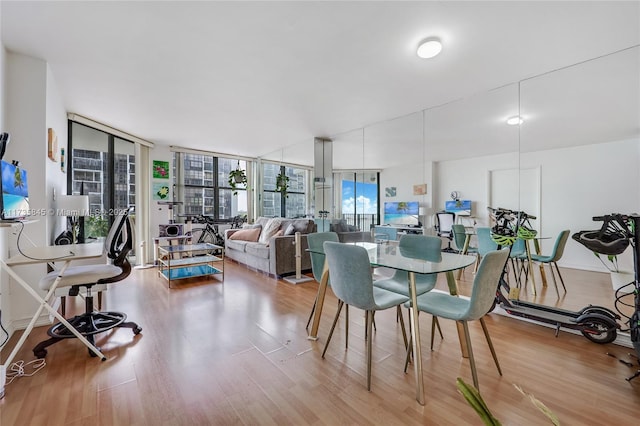 dining area featuring hardwood / wood-style flooring and floor to ceiling windows