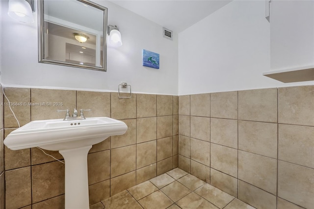 bathroom with tile walls