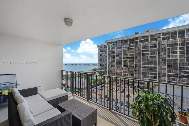 balcony featuring a water view and an outdoor hangout area