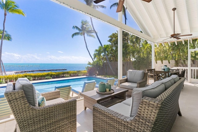 view of patio with an outdoor living space, a water view, a fenced in pool, and ceiling fan