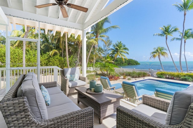 exterior space with a water view, ceiling fan, a healthy amount of sunlight, and lofted ceiling