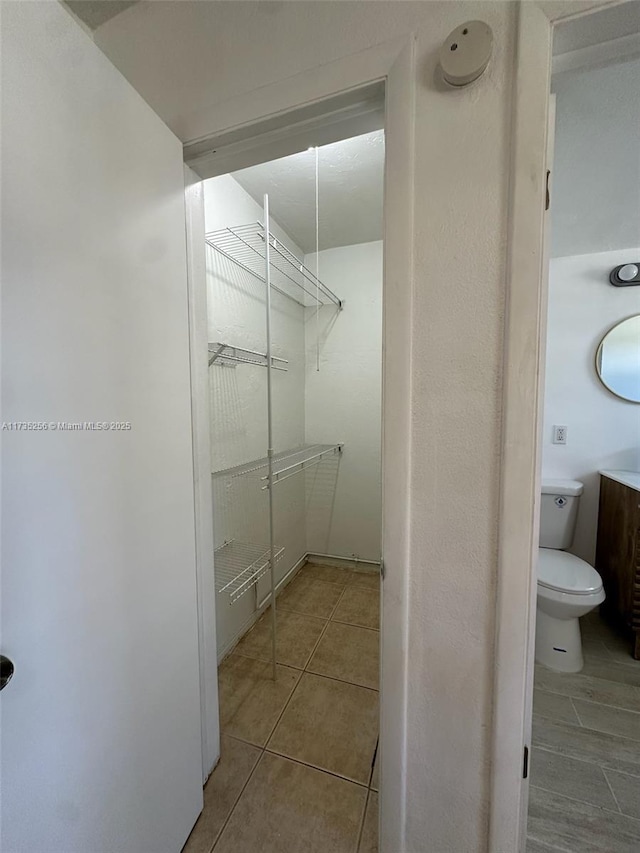 bathroom with tile patterned floors and toilet