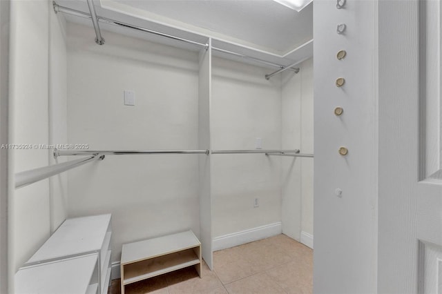 spacious closet with light tile patterned floors