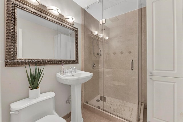 bathroom featuring sink, toilet, and walk in shower