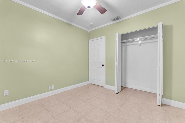 unfurnished bedroom featuring light tile patterned floors, ornamental molding, a closet, and ceiling fan