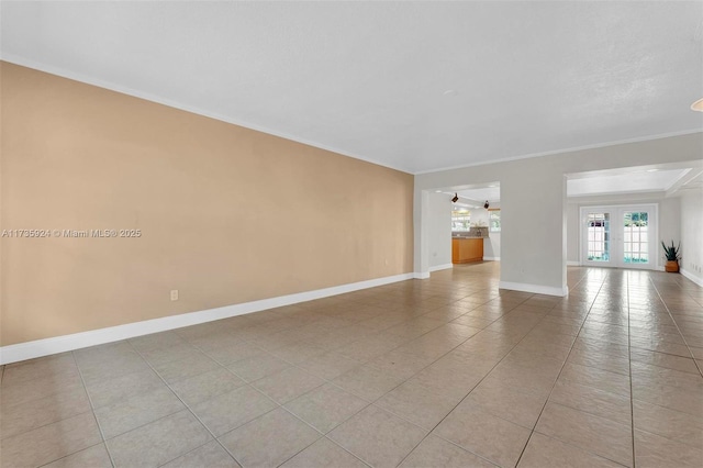 tiled spare room with crown molding and french doors