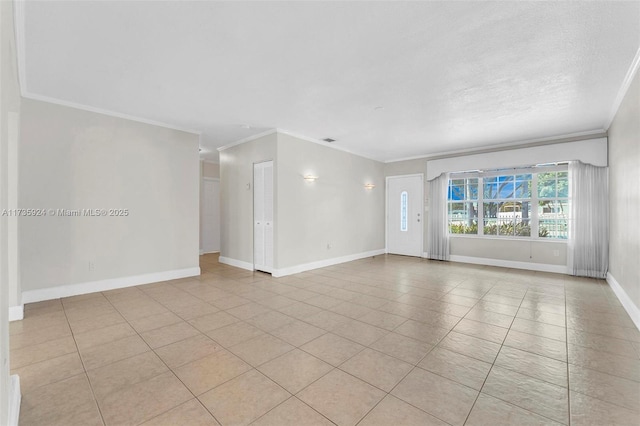 spare room featuring crown molding, light tile patterned flooring, and a textured ceiling