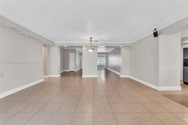 empty room featuring light tile patterned floors and ornamental molding