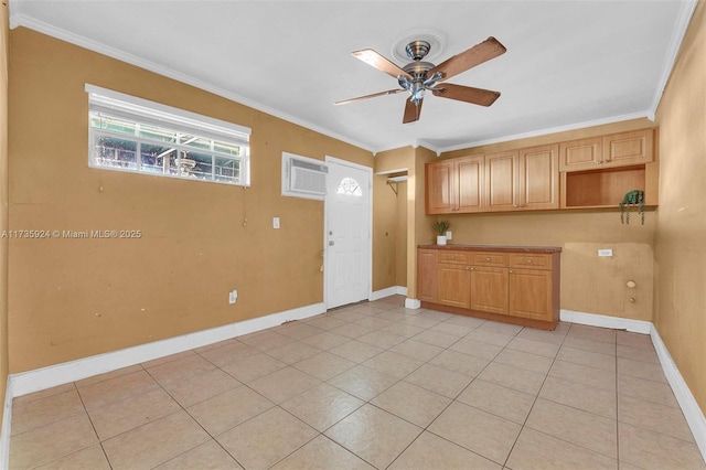 kitchen with ornamental molding, an AC wall unit, ceiling fan, and light brown cabinets