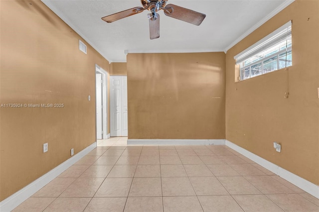 empty room featuring crown molding, ceiling fan, and light tile patterned flooring