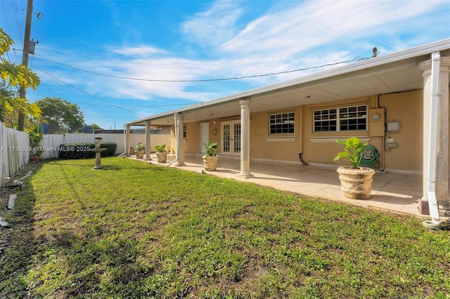 back of house featuring a yard and a patio area