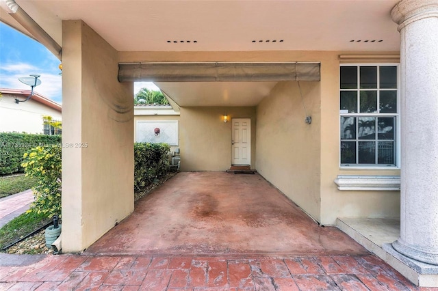 view of exterior entry with a patio area