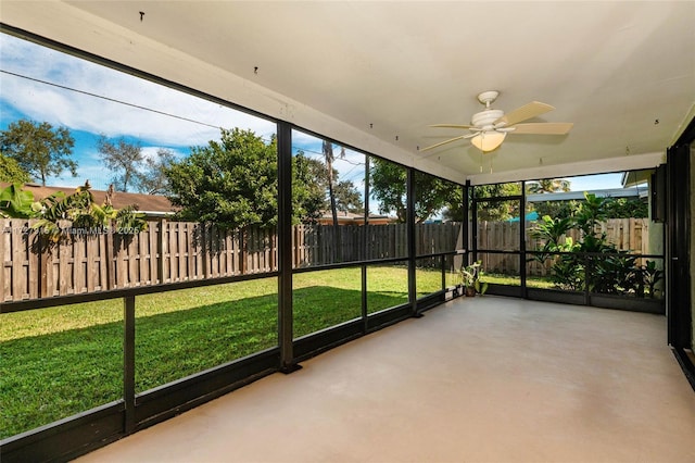 unfurnished sunroom featuring ceiling fan