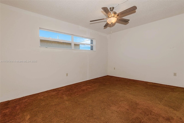 carpeted spare room with ceiling fan and a textured ceiling