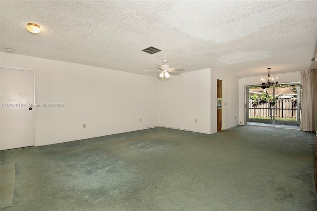 spare room featuring ceiling fan with notable chandelier, carpet, and a textured ceiling