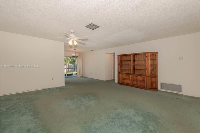 interior space featuring ceiling fan with notable chandelier, carpet floors, and a textured ceiling